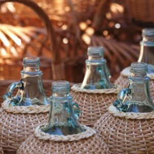 woven baskets around glass wine bottles